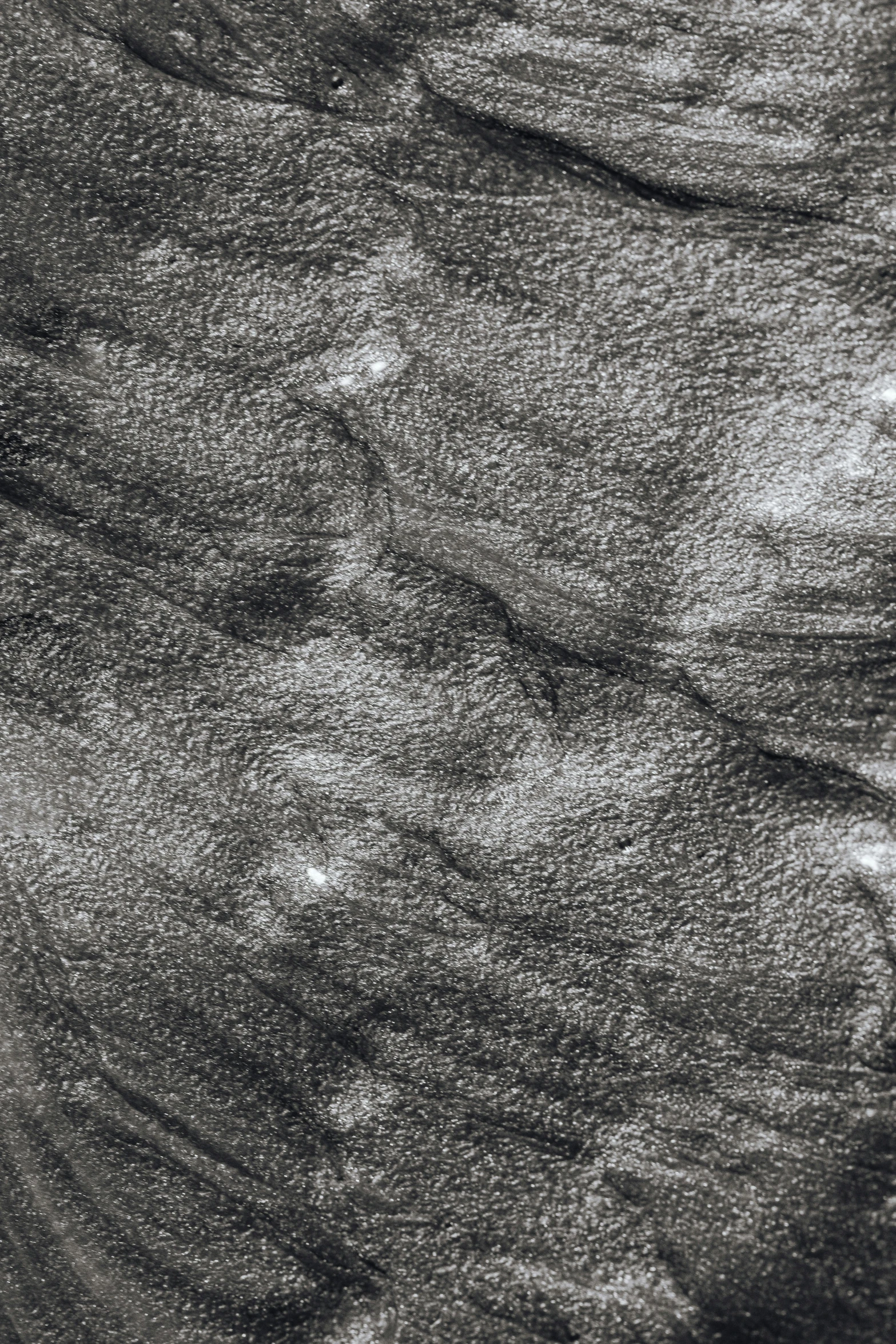 a black and white photo of a rock face, an ultrafine detailed painting, inspired by Matthijs Maris, detail texture, swirling fabric, in gunmetal grey, pastel'