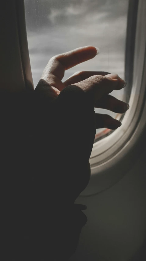 a hand reaching out of an airplane window, pexels, hurufiyya, faceless people dark, vintage style, flat, thumbnail