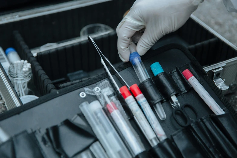 a person holding a pair of scissors in a case, by Julia Pishtar, pexels contest winner, pathology sample test tubes, iv pole, crimes, extremely hyperdetailed