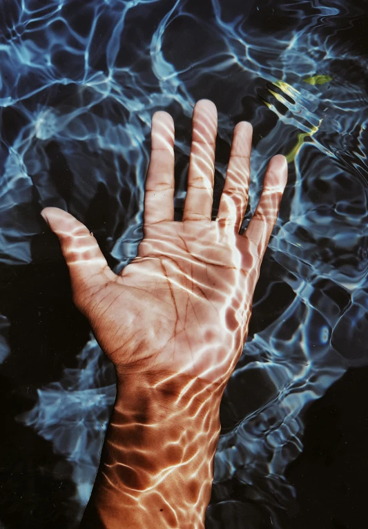 a person's hand in a pool of water, a photorealistic painting, unsplash, zeng fanzhi, sunlight, taken in the late 2000s, vapourwave