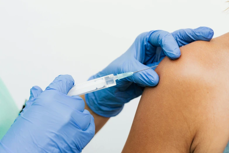 a woman getting an injection from a doctor, a picture, shutterstock, thighs close up, from the elbow, 90s photo, thumbnail