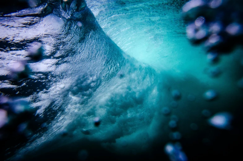 a man riding a wave on top of a surfboard, by Peter Churcher, unsplash, underwater crystals, deep colours. ”, blue ice, viewed from bellow