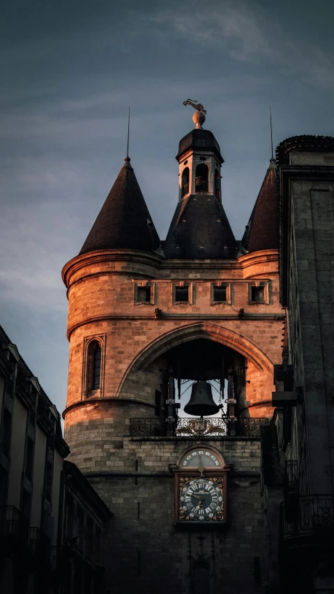 a clock that is on the side of a building, an album cover, inspired by Pierre Toutain-Dorbec, pexels contest winner, romanesque, at dusk, rennes - le - chateau, bells, arch