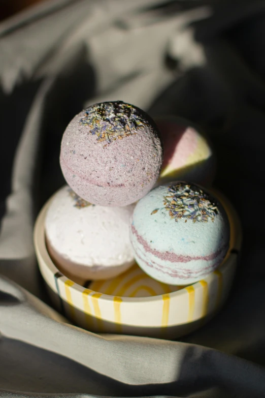 three bath bombs stacked on top of each other, a portrait, inspired by Eden Box, unsplash, baroque, mini planets, full shot, potions, detailed product image