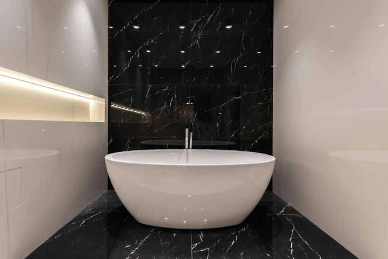 a large white bath tub sitting inside of a bathroom, a marble sculpture, by Patrick Pietropoli, pexels contest winner, black marble, 3d lighting, black, panels