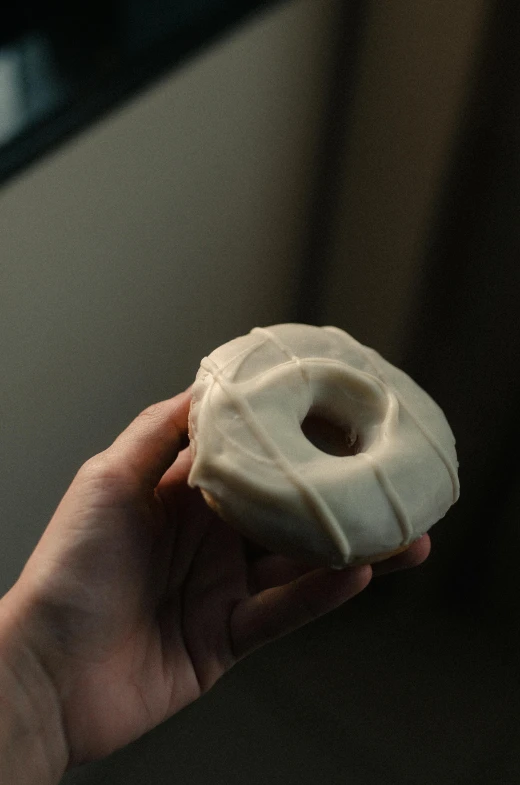 a person holding a doughnut in their hand, a marble sculpture, by Jessie Algie, unsplash, renaissance, intense albino, bakery, carved ivory, made of glazed