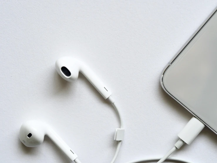 a pair of ear buds sitting next to a cell phone, trending on pexels, minimalism, white color scheme, cords, background image, intricately