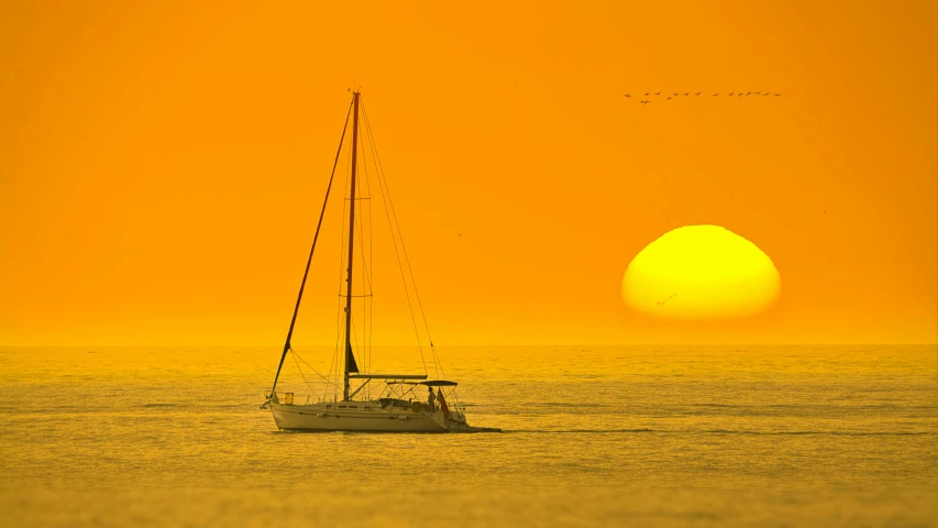 a sailboat in the middle of the ocean at sunset, by Peter Churcher, pexels contest winner, romanticism, yellow, abel tasman, suns, phot