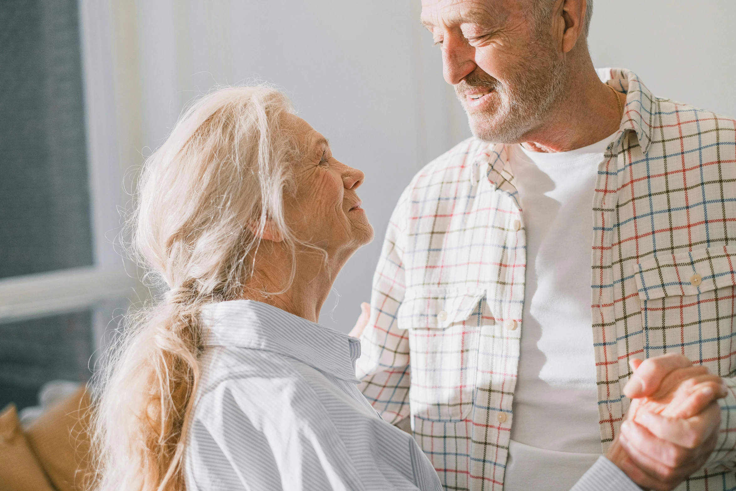 a man and woman dancing together in a living room, by Lee Loughridge, pexels contest winner, an old man with a ginger beard, smiling softly, profile image, couple on bed