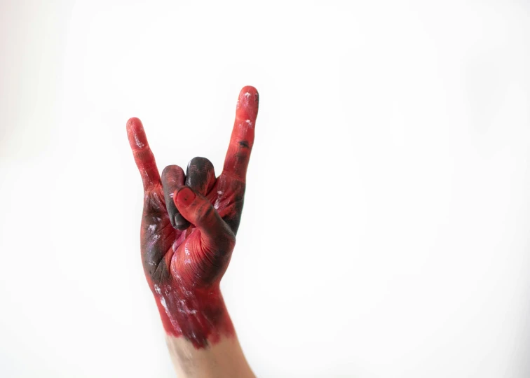 a person making a peace sign with their hands, an album cover, pexels, made of blood, bodypainting, i love you, hziulquoigmnzhah