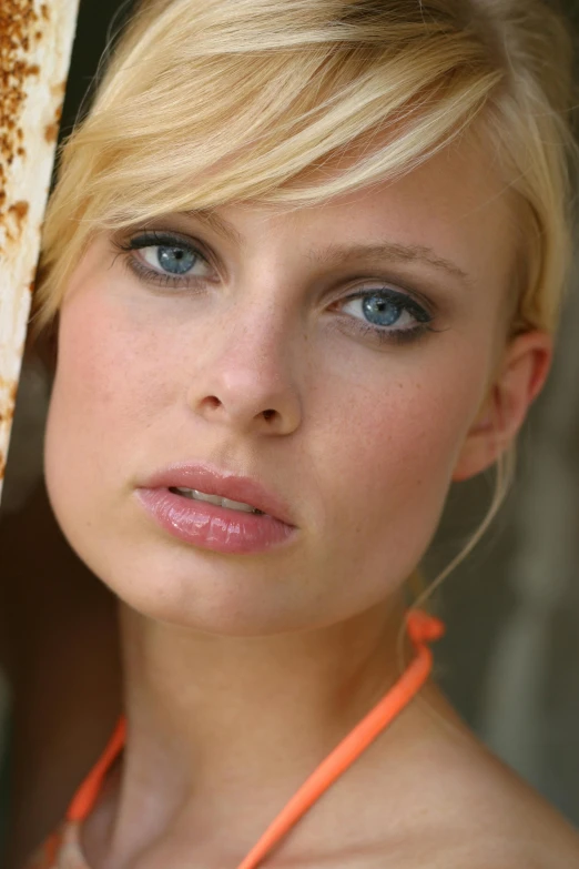 a woman in a bikini posing for a picture, blue eyes and large forehead, headshot profile picture, close-up photograph, item