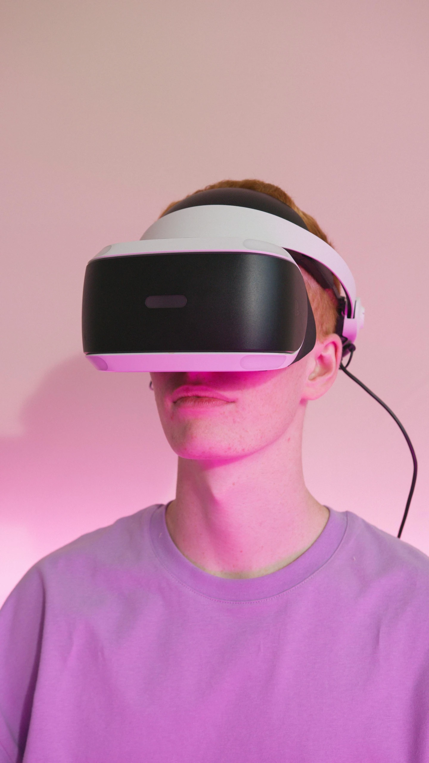 a man in a purple shirt wearing a virtual reality headset, by Carey Morris, reddit, hypermodernism, glowing pink face, hyperrealistic teen, linus tech tips, press shot