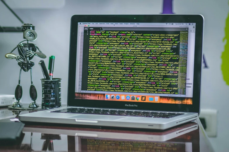 a laptop computer sitting on top of a desk, pexels, computer code, intricated, large screen, cover shot