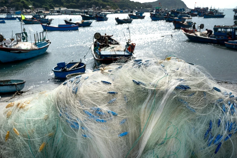 a number of boats in a body of water, pexels contest winner, net art, plastic sea wrapped, farming, cover shot, textiles