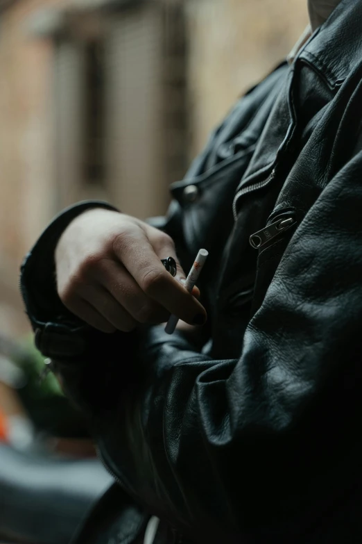 a man in a leather jacket smoking a cigarette, trending on pexels, rectangle, faded, weed, hand on hip