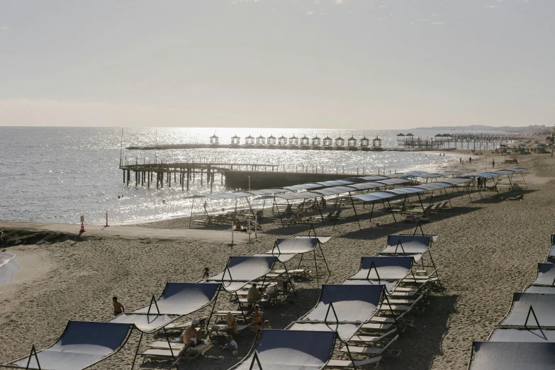 a beach filled with lots of chairs and umbrellas, a portrait, by Carlo Martini, unsplash contest winner, renaissance, soft morning light, bulgari, ignant, turkey