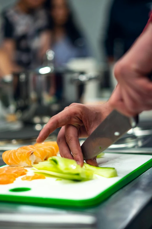 a person cutting up vegetables on a cutting board, gourmet michelin restaurant, educational, performance, in a kitchen