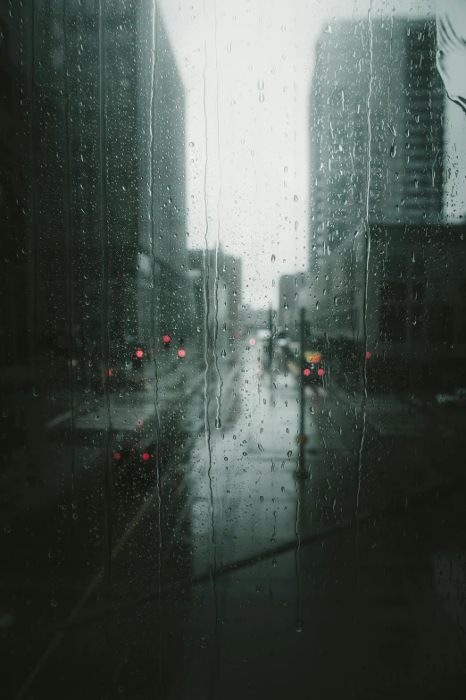 a view of a city through a rainy window, unsplash contest winner, tonalism, ) ominous vibes, city street, downtown, taken in the 2000s