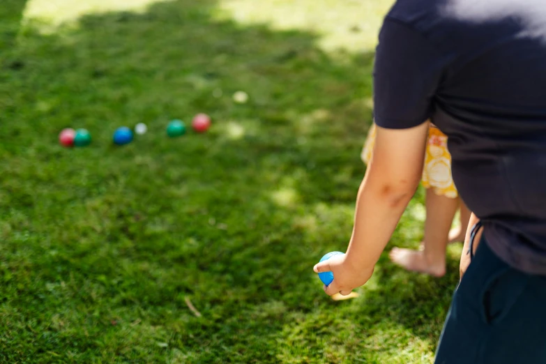 a little boy standing on top of a lush green field, a child's drawing, by Julian Allen, unsplash, launching a straight ball, children playing with pogs, closeup of arms, tournament
