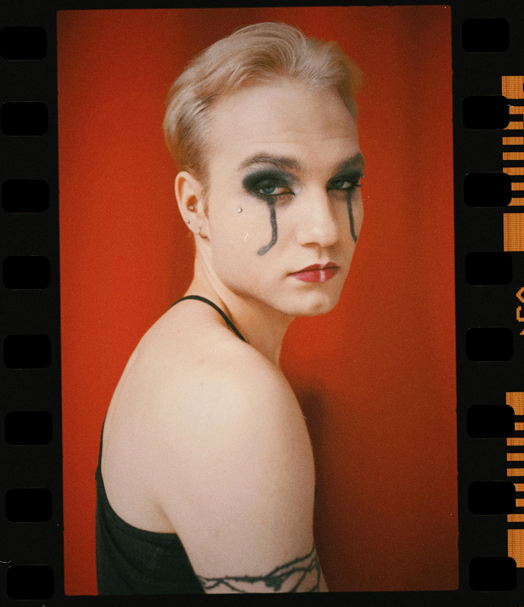 a close up of a person with makeup on, a polaroid photo, flickr, visual art, portrait of circus artist, tears, 256435456k film, non binary model