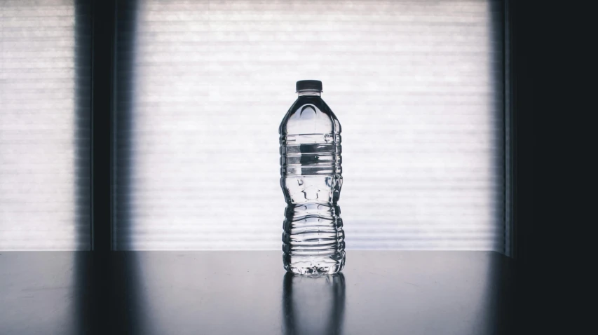 a bottle of water sitting on top of a table, pexels contest winner, plasticien, plain background, unedited, full-body, thumbnail