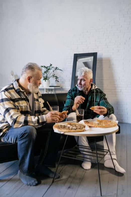 two older men sitting at a table eating pizza, pexels contest winner, two buddies sitting in a room, gray men, profile image, two skinny old people