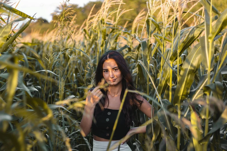 a beautiful young woman standing in a corn field, pexels contest winner, avatar image, isabela moner, college, bella poarch