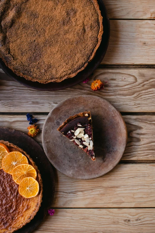 a cake sitting on top of a wooden table, a still life, by Lee Loughridge, shutterstock contest winner, moroccan, crust, botanicals, fully chocolate