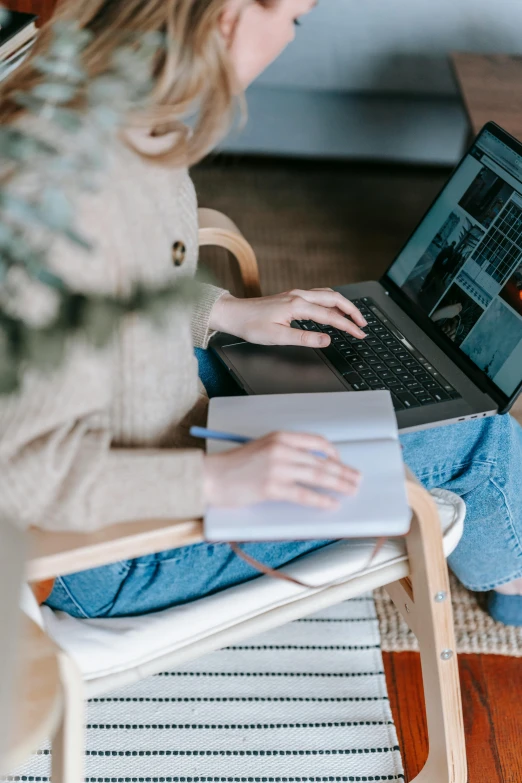 a woman sitting in a chair using a laptop, trending on pexels, seasonal, thumbnail, student, 1 2 9 7