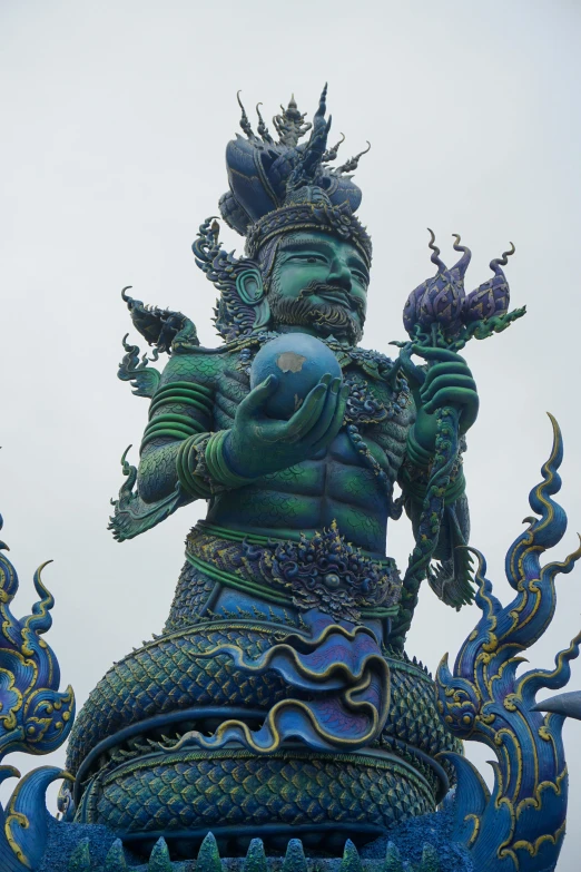 a statue of a dragon on top of a building, blue-green fish skin, attractive male deity, standing on neptune, taken in the late 2000s