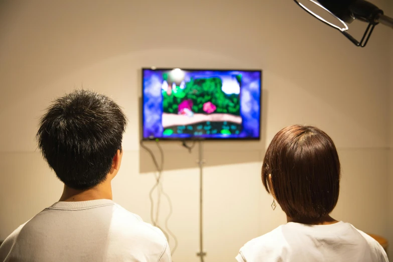 a couple of people sitting in front of a tv, by Miyamoto, close-up shot taken from behind, an escape room in a small, high resolution!!, trending onstudio ghibli