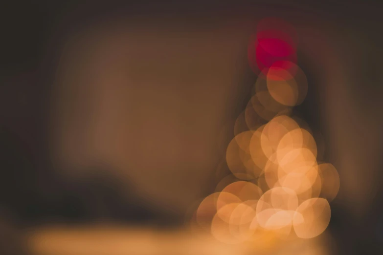 a blurry photo of a christmas tree in a dark room, by Jesper Knudsen, unsplash, multiple stories, brown, background image, lensflares