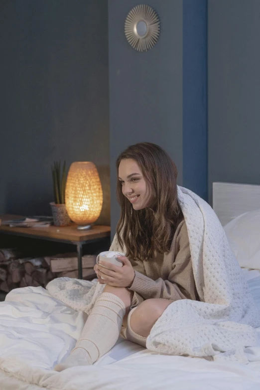 a woman sitting on top of a bed under a blanket, teenager hangout spot, wearing nanotech honeycomb robe, happy ambience, indoor lighting