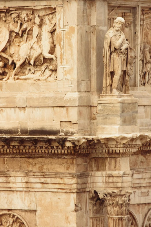 a group of statues on the side of a building, by Michelangelo, neoclassicism, castles and temple details, upclose, arches, constantine