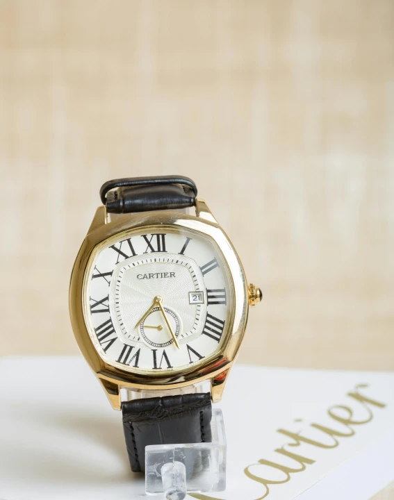 a close up of a watch on a table, inspired by Cafer Bater, featured on instagram, gold details, set against a white background, thumbnail, shaped picture