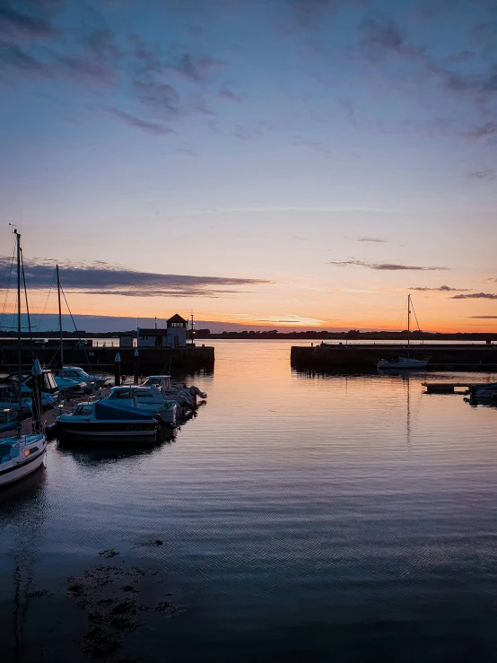 a group of boats sitting on top of a body of water, by Kev Walker, pexels contest winner, maryport, magic hour, 2022 photograph, thumbnail