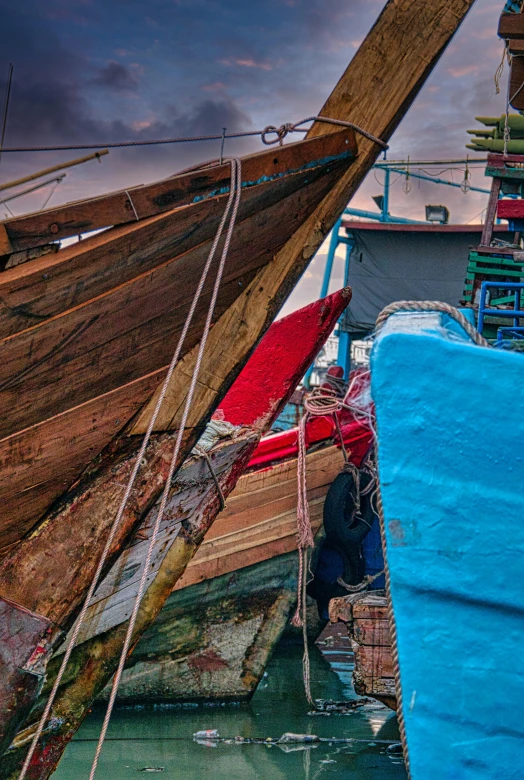 a boat sitting on top of a body of water, inspired by Steve McCurry, pexels contest winner, process art, fish market stalls, strong colours, torn sails, hdr detail