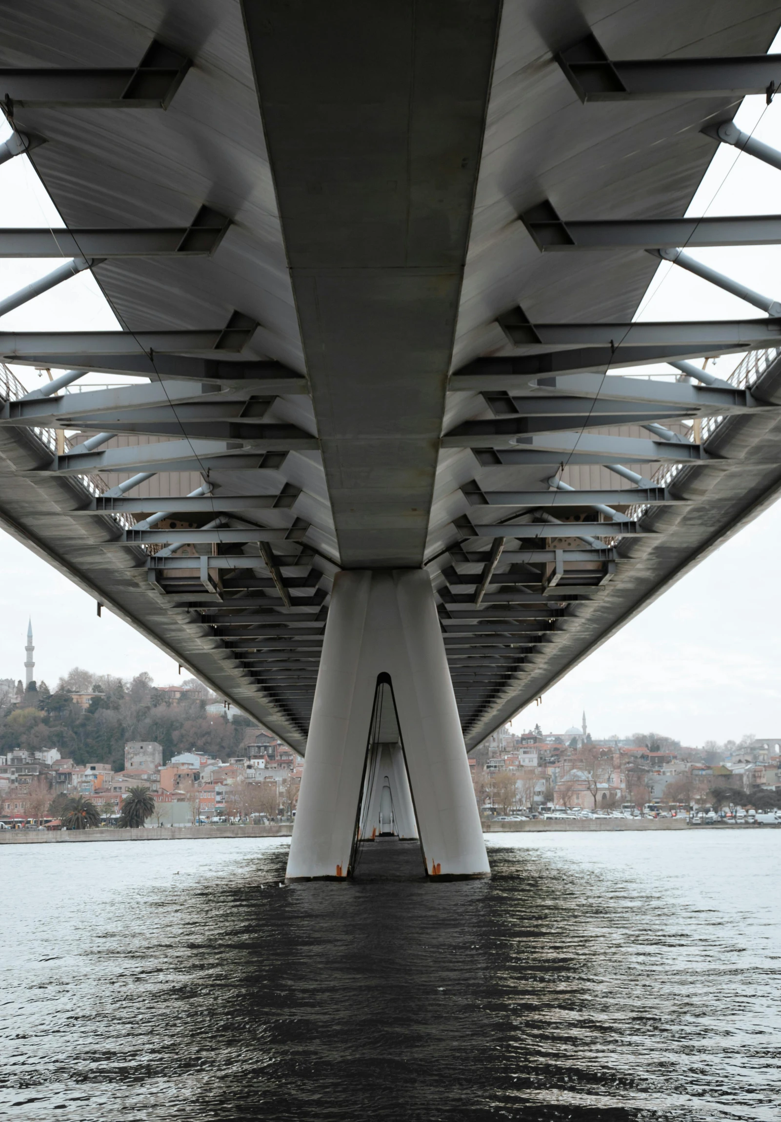 the underside of a bridge over a body of water, istanbul, slide show, grey, large tall