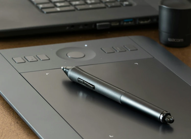 a pen sitting on top of a tablet next to a laptop, pexels contest winner, computer art, computer equipment, intricate detailing, rectangle, realistic graphite