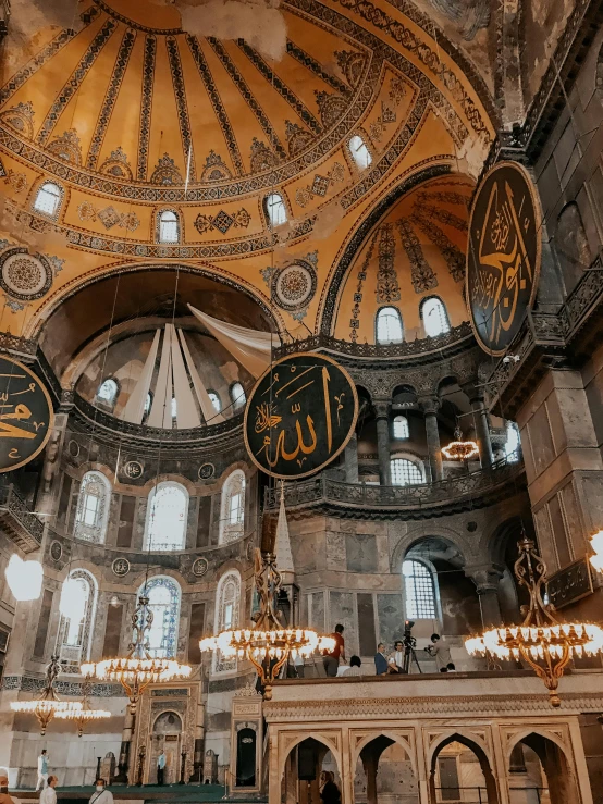 a group of people standing inside of a building, a colorized photo, pexels contest winner, hurufiyya, with great domes and arches, 🚿🗝📝