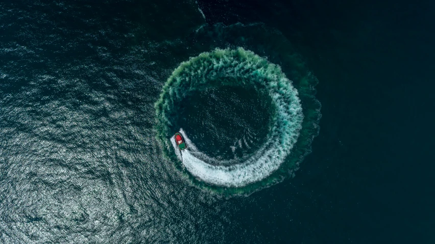 a boat in the middle of a body of water, by Jacob Toorenvliet, pexels contest winner, hurufiyya, complex vortex, tubing, reefs, the ring