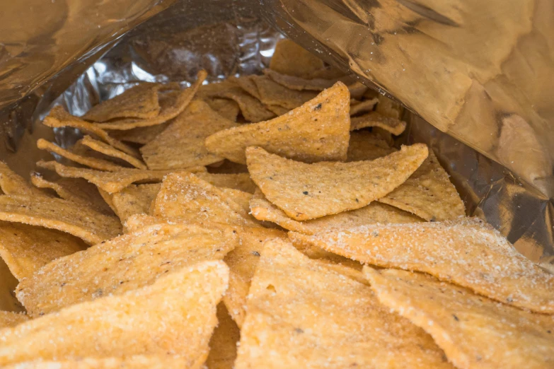 a bag of chips sitting on top of a table, chilaquiles, digital image, close-ups, backfacing