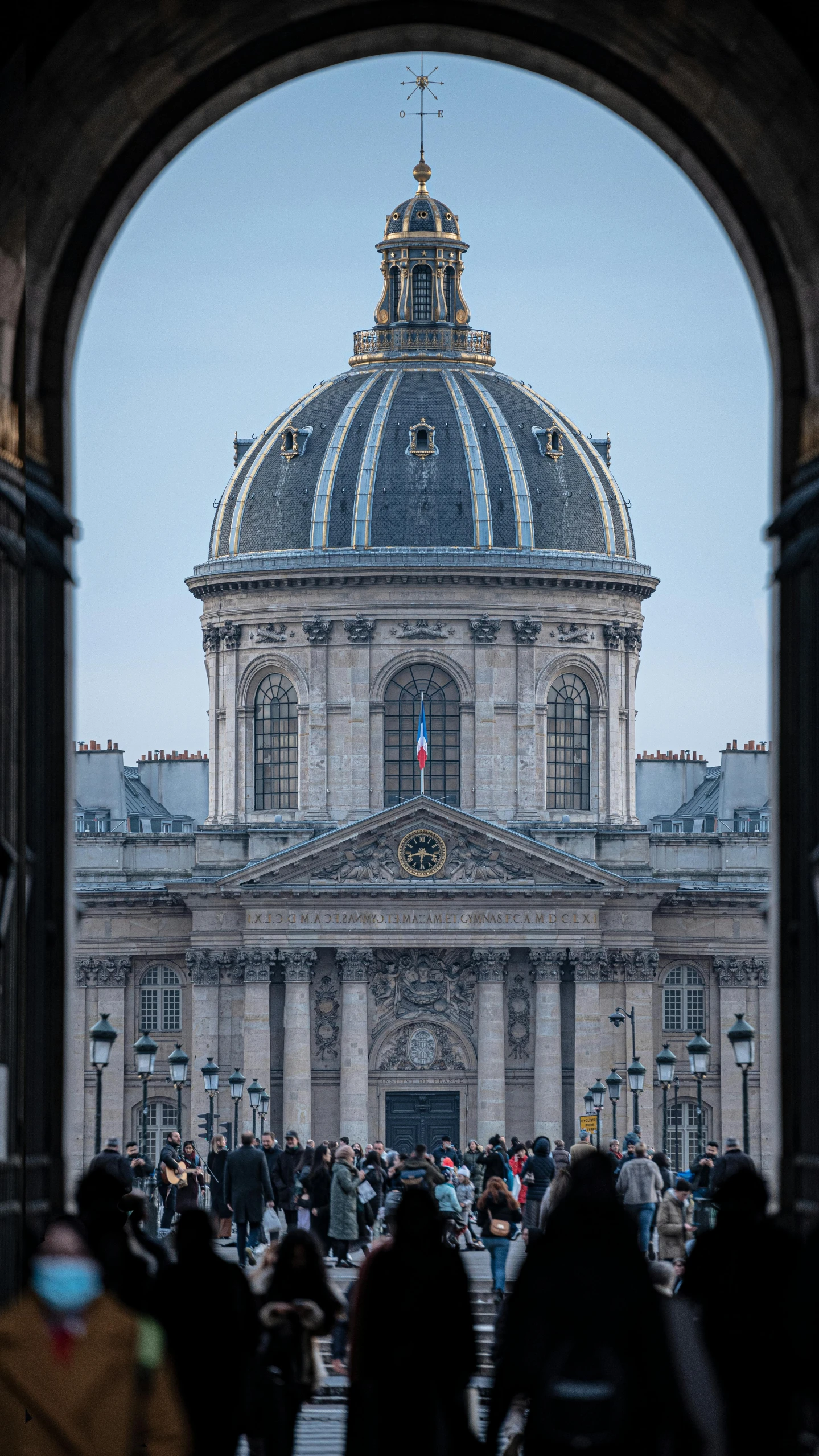 a group of people standing in front of a building, a photo, inspired by Jean-François de Troy, trending on unsplash, paris school, dome, full front view, looking through a portal, high angle close up shot