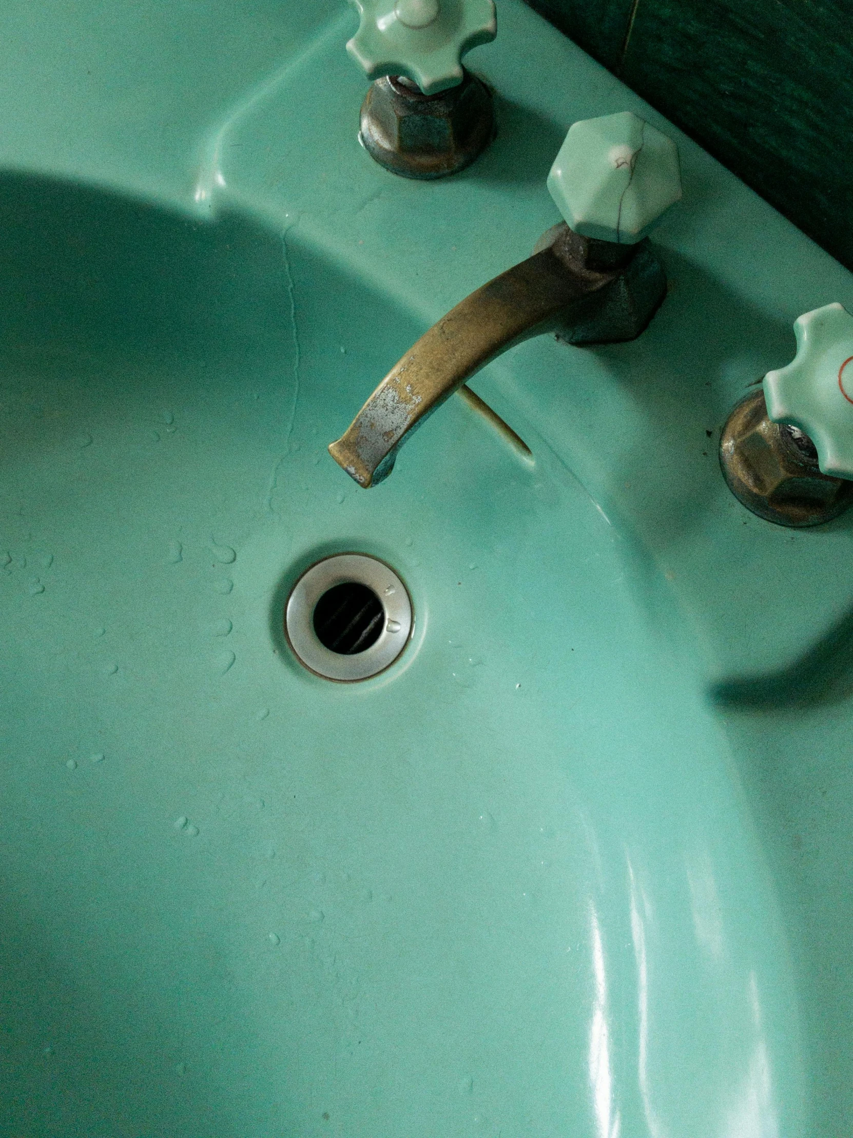 a bathroom sink with a faucet and soap dispenser, inspired by Elsa Bleda, hyperrealism, ((greenish blue tones)), crawling in a wet sewer pipe, pareidolia, seafoam green