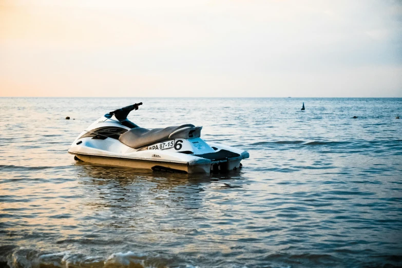 a jet ski sitting on top of a body of water, unsplash, fan favorite, hull, 2000s photo, seaside