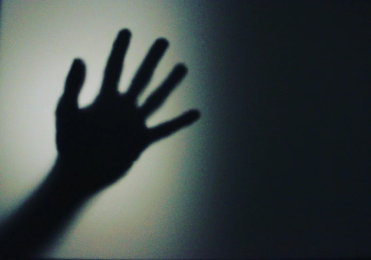 a shadow of a person's hand on a wall, pexels, surrealism, eery light, instagram photo, still from horror movie, waving