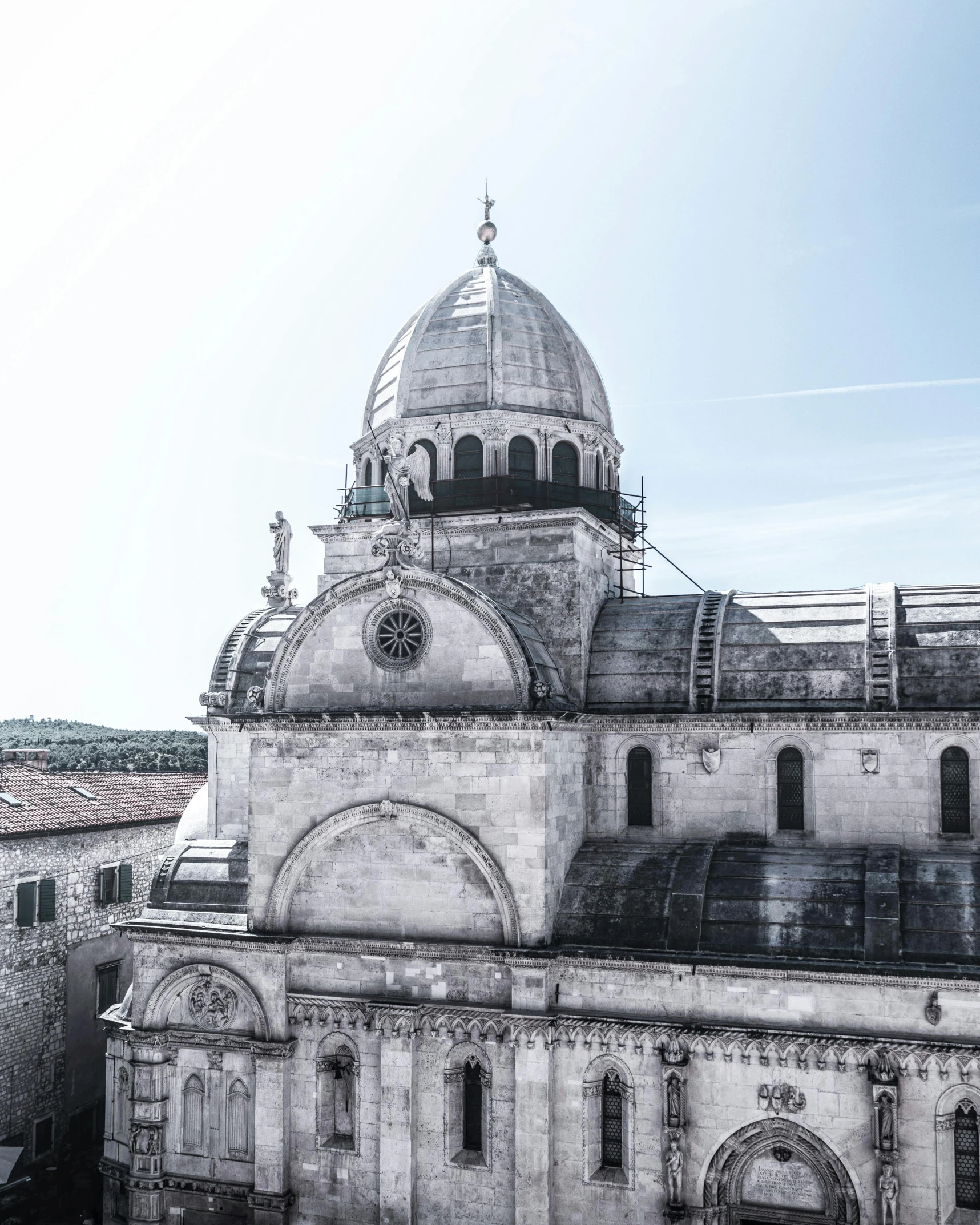 a black and white photo of a large building, inspired by Jacopo de' Barbari, unsplash contest winner, romanesque, dome, color picture, overlooking, split near the left