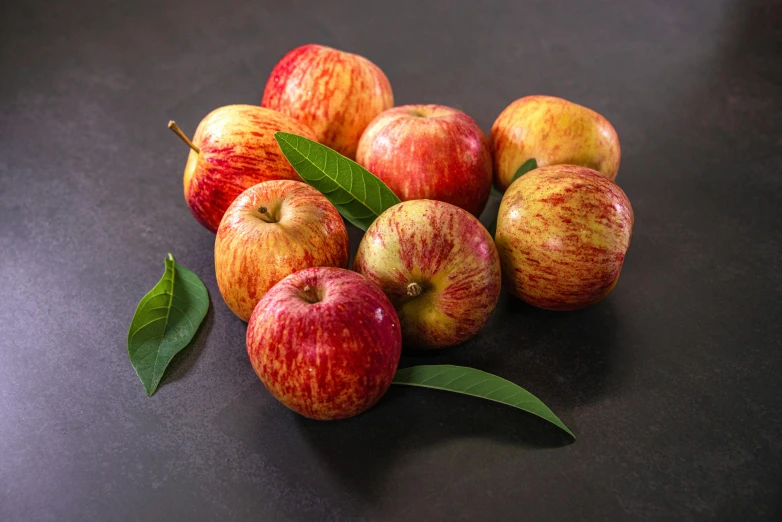 a pile of apples sitting on top of a table, official product photo, group of seven, vibrant foliage, on grey background