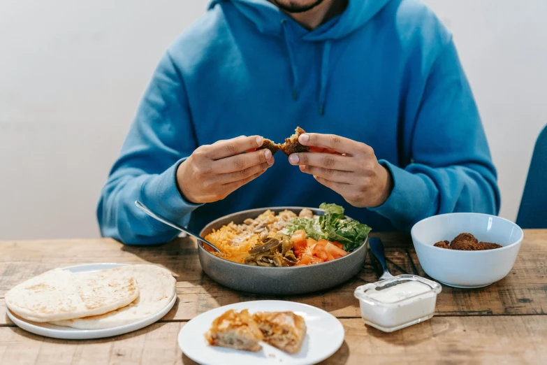 a man sitting at a table with a bowl of food, pexels contest winner, lachlan bailey, ready to eat, casually dressed, logo for lunch delivery