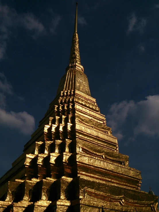 a golden pagoda with a blue sky in the background, an album cover, in 2 0 0 2, taken in the late 2010s, 1999 photograph, golden thread